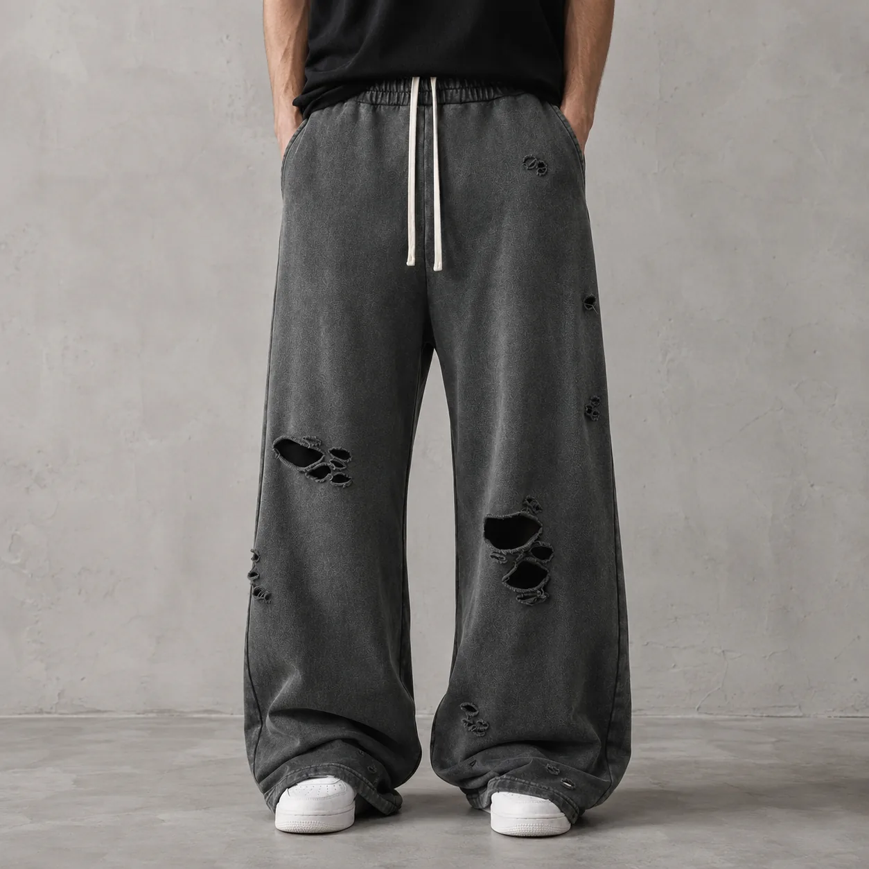 Model wearing charcoal 430GSM wax-dyed distressed cotton wide-leg joggers