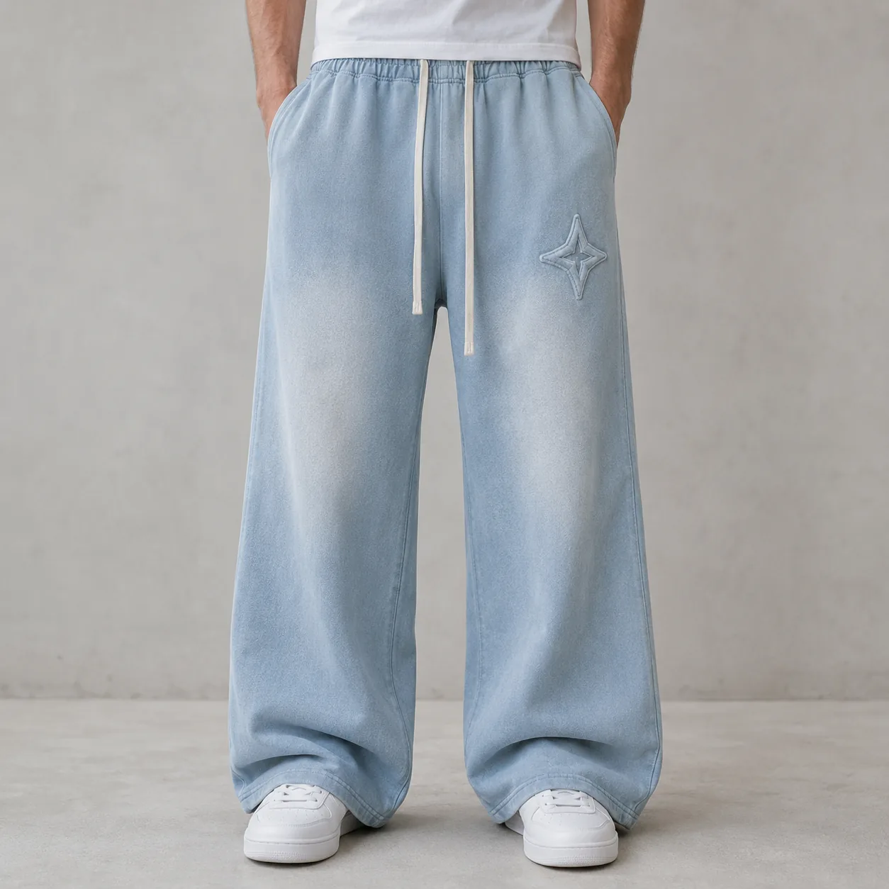 Model wearing light blue 360GSM cotton-blend spray-washed loose-fit joggers