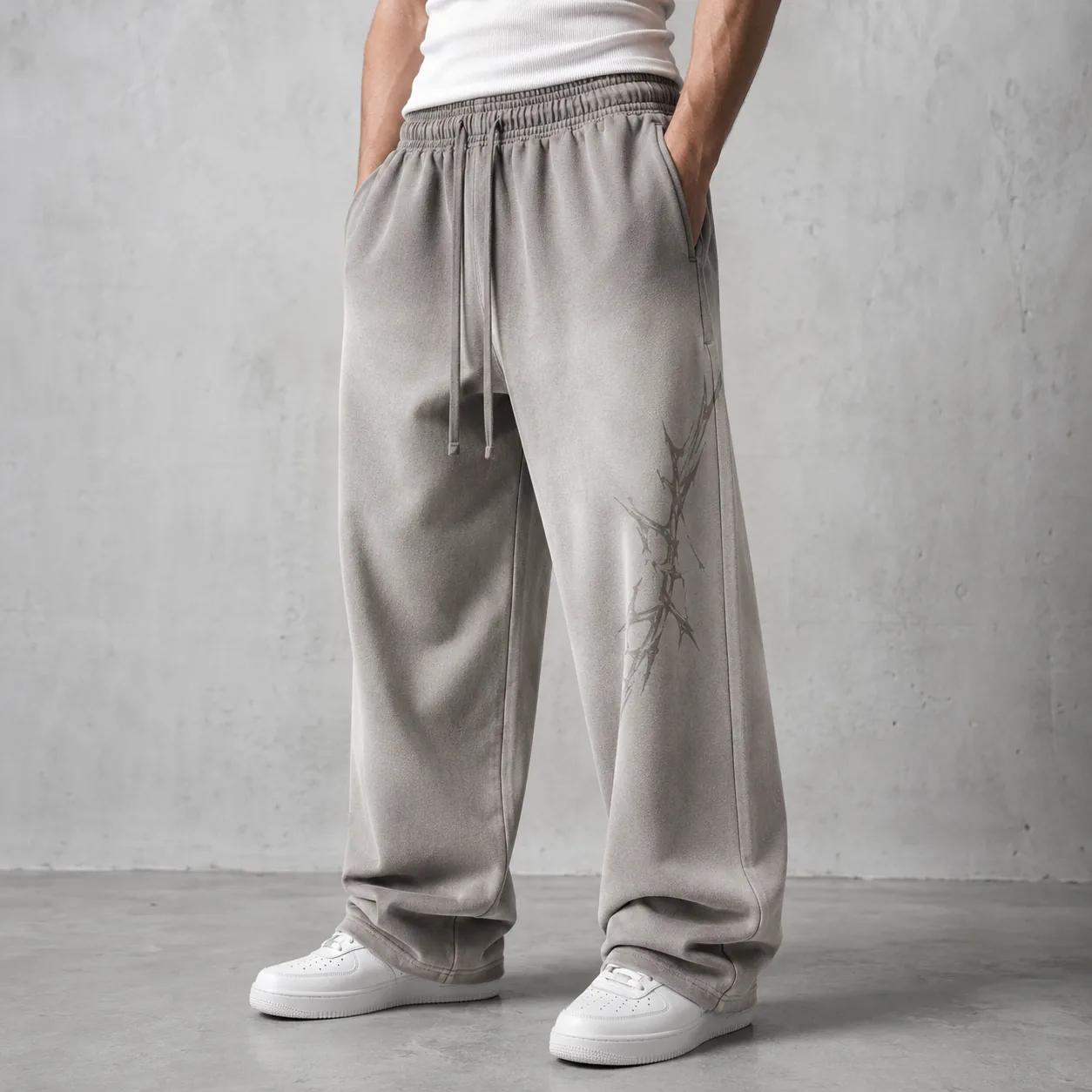 Model wearing grey 450GSM spray-washed cotton-blend loose-fit joggers