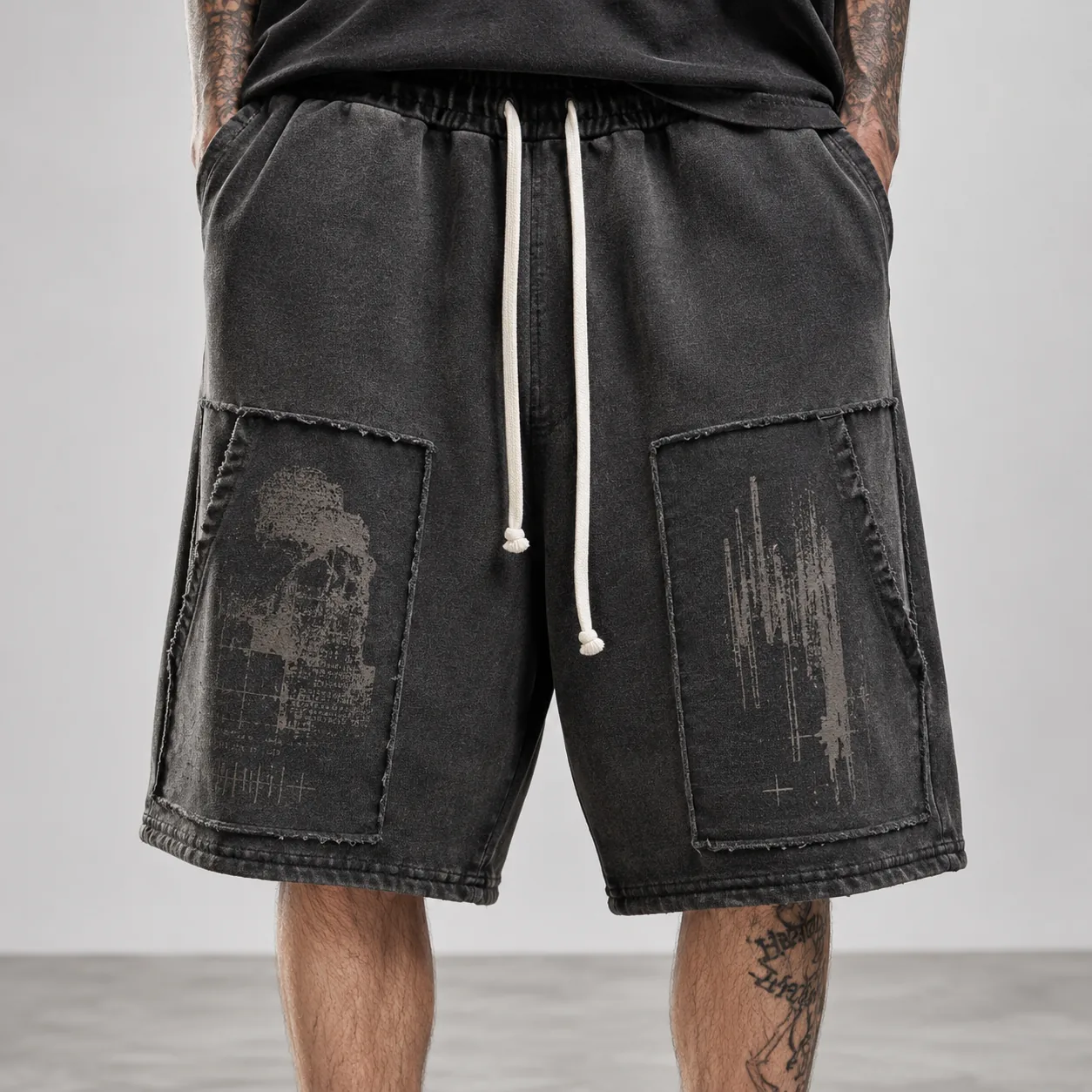 Black 380GSM wax-dyed cotton terry shorts with distressed panel pockets