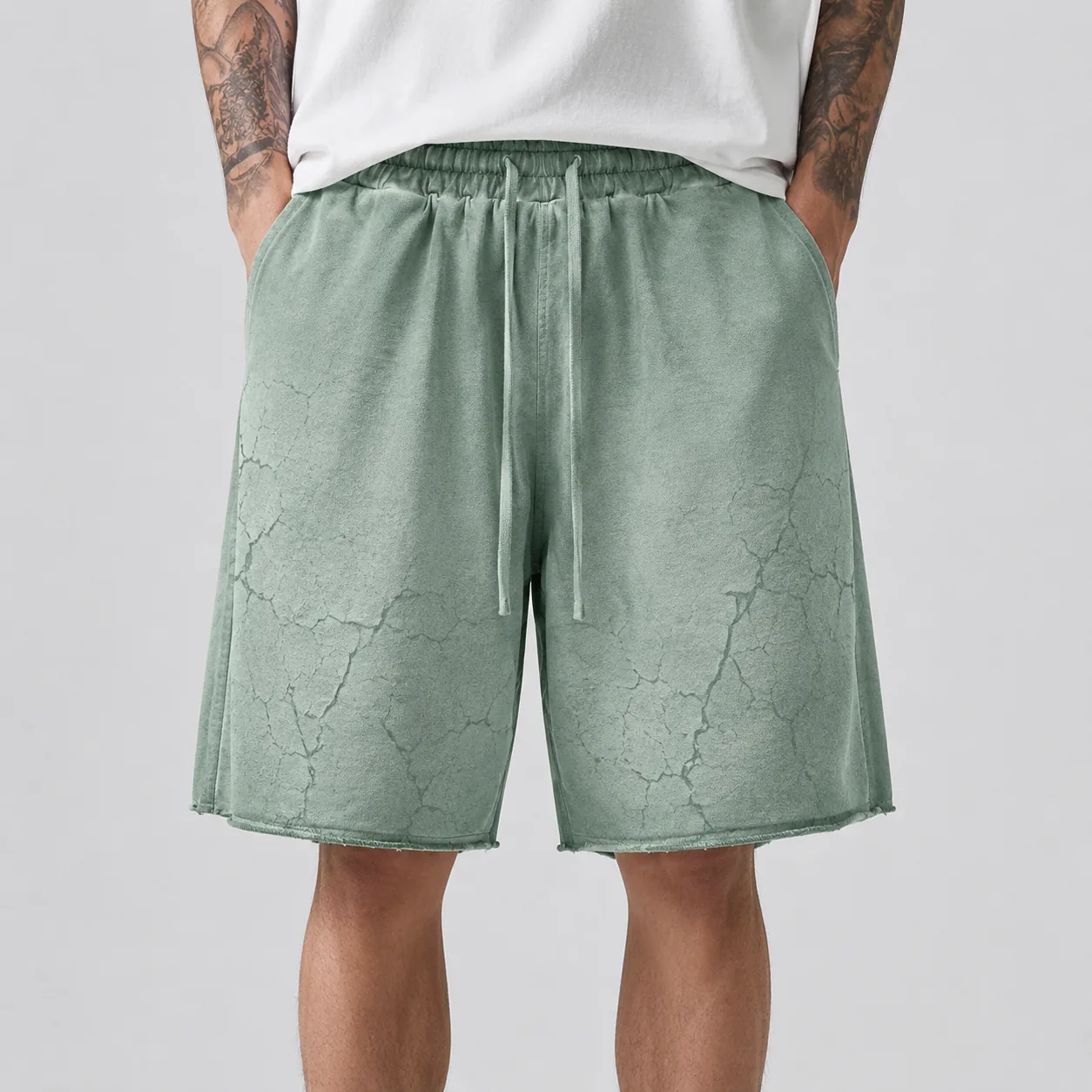 Sage reverse-washed cotton-blend loose-fit shorts with distressed surface