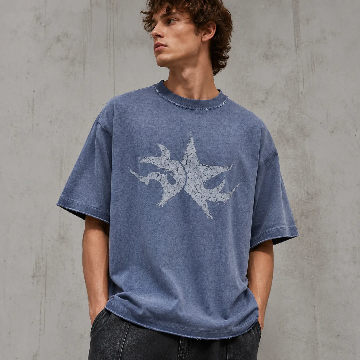 Washed blue 275GSM cotton T-shirt with distressed surface and representative graphic