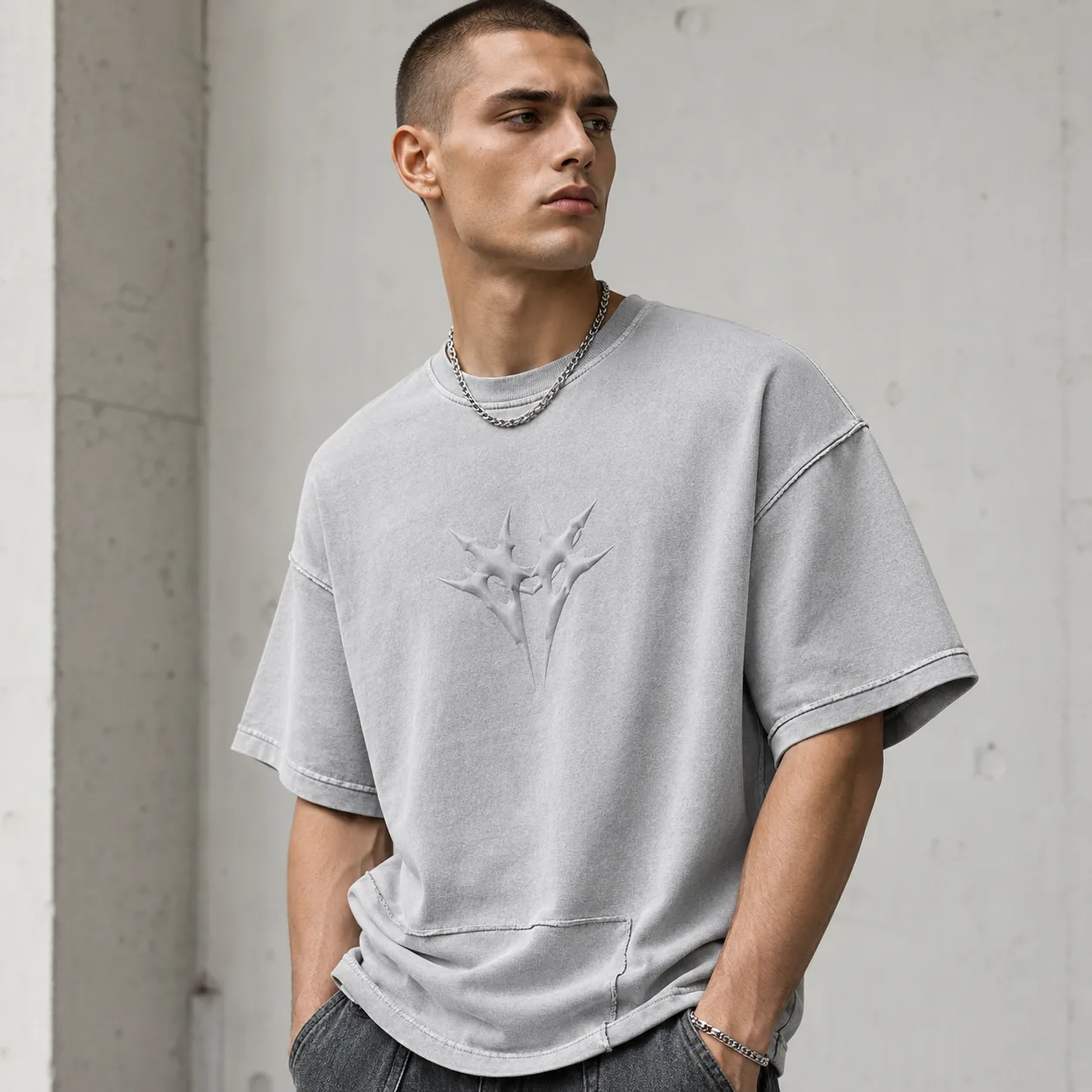 Light grey 275GSM sand-washed cotton T-shirt with panelled seams and representative tonal graphic